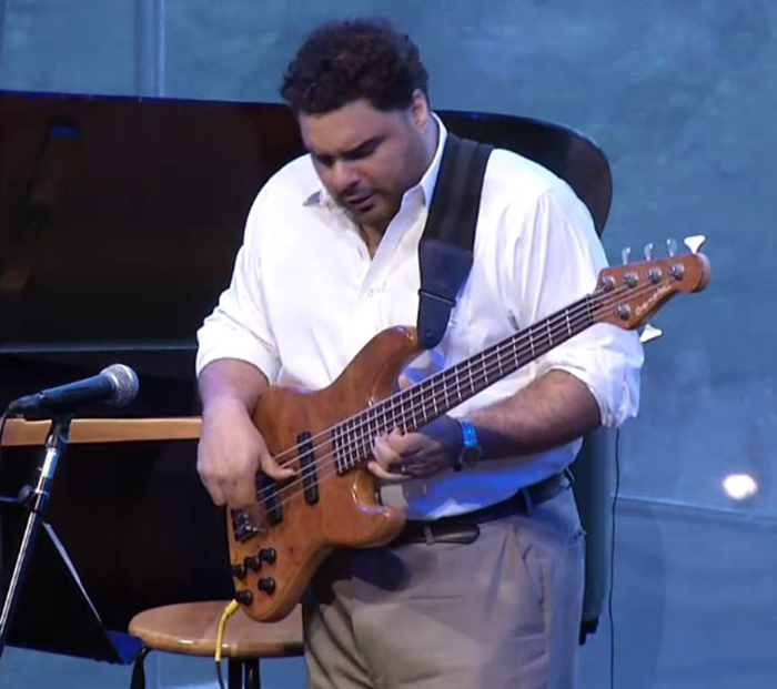 Bassist Carlos Henriquez plays his Overwater Hybrid 5 string bass