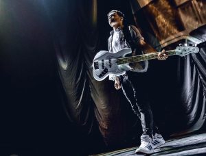 overwater bassist sandy Beales onstage with white j series